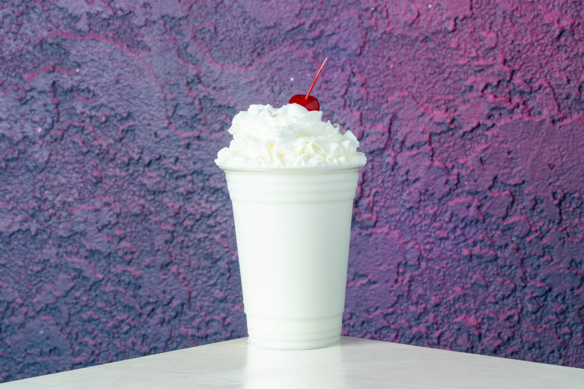 Space Dogs vanilla milkshake topped with whipped cream and a cherry